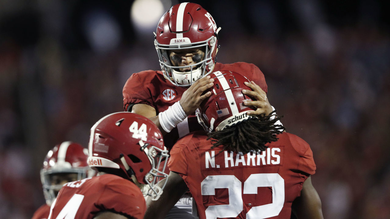 ORLANDO, FL - SEPTEMBER 01: Tua Tagovailoa #13 of the Alabama Crimson Tide celebrates with Najee Harris #22 after his one-yard touchdown run in the second quarter of the game against the Louisville Cardinals at Camping World Stadium on September 1, 2018 in Orlando, Florida.