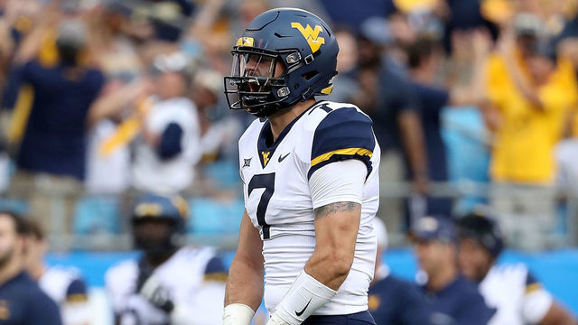 CHARLOTTE, NC - SEPTEMBER 01: Will Grier #7 of the West Virginia Mountaineers reacts after throwing a touchdown pass against the Tennessee Volunteers during their game at Bank of America Stadium on September 1, 2018 in Charlotte, North Carolina.