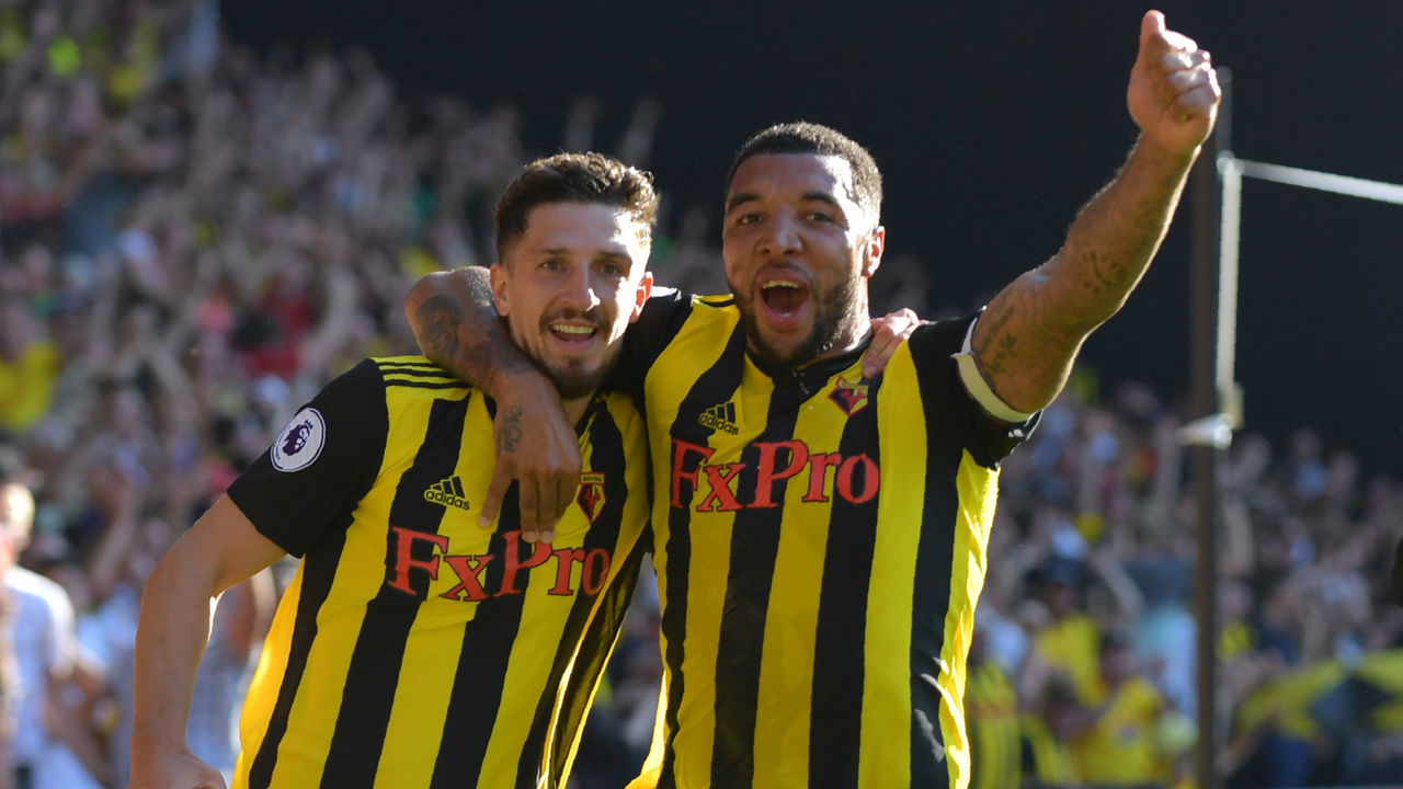 Watford's Northern Irish defender Craig Cathcart (L) celebrates with Watford's English striker Troy Deeney after scoring their second goal during the English Premier League football match between Watford and Tottenham Hotspur at Vicarage Road Stadium in Watford, north of London on September 2, 2018.