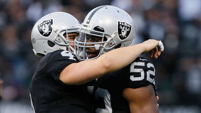 OAKLAND, CA - DECEMBER 04: Khalil Mack #52 of the Oakland Raiders celebrates with Derek Carr #4 after a fumble recovery against the Buffalo Bills during their NFL game at Oakland Alameda Coliseum on December 4, 2016 in Oakland, California.