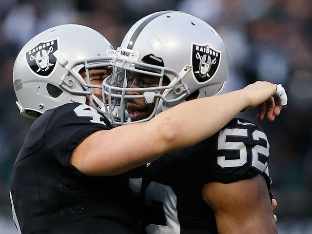 OAKLAND, CA - DECEMBER 04: Khalil Mack #52 of the Oakland Raiders celebrates with Derek Carr #4 after a fumble recovery against the Buffalo Bills during their NFL game at Oakland Alameda Coliseum on December 4, 2016 in Oakland, California.