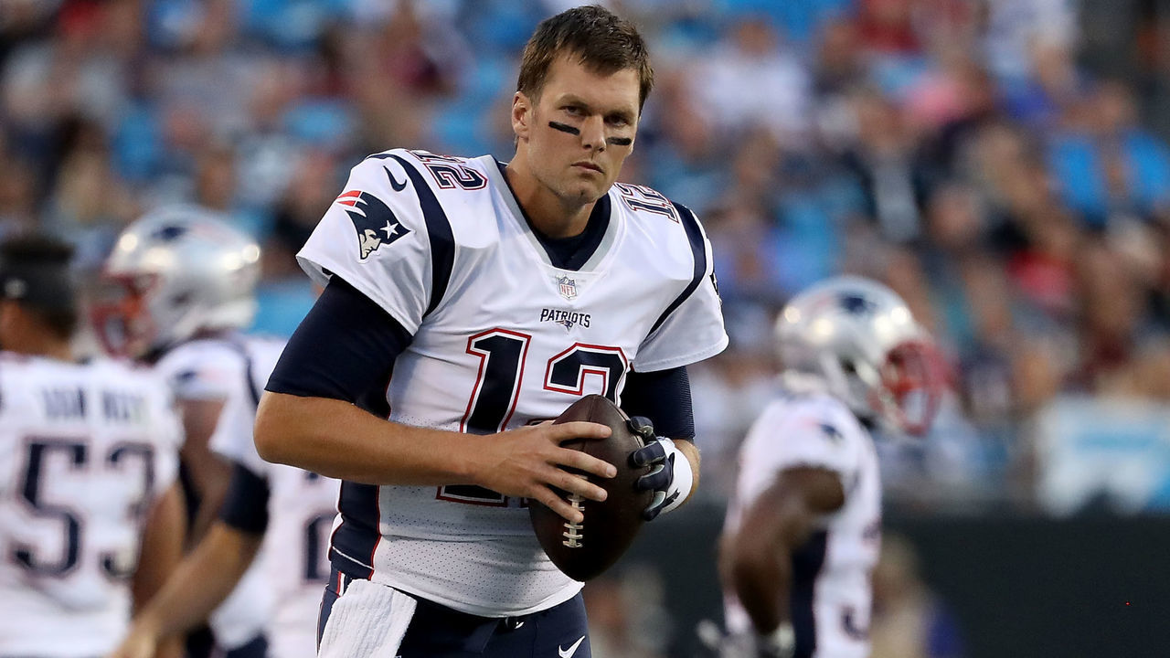 CHARLOTTE, NC - AUGUST 24: Tom Brady #12 of the New England Patriots stays loose on the sideline against the Carolina Panthers in the first quarter during their game at Bank of America Stadium on August 24, 2018 in Charlotte, North Carolina.