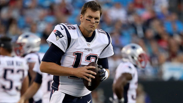 CHARLOTTE, NC - AUGUST 24: Tom Brady #12 of the New England Patriots stays loose on the sideline against the Carolina Panthers in the first quarter during their game at Bank of America Stadium on August 24, 2018 in Charlotte, North Carolina.