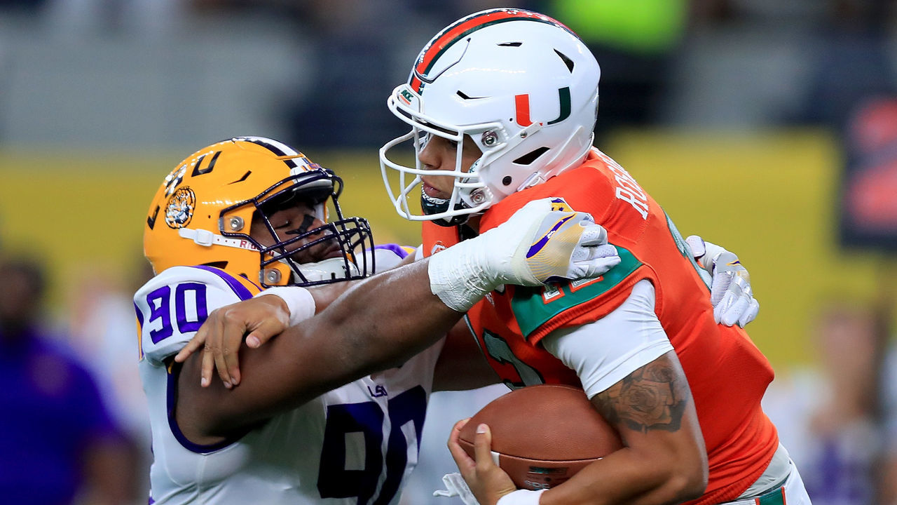ARLINGTON, TX - SEPTEMBER 02: Malik Rosier #12 of the Miami Hurricanes is sacked by Rashard Lawrence #90 of the LSU Tigers in the first quarter of The AdvoCare Classic at AT&T Stadium on September 2, 2018 in Arlington, Texas.