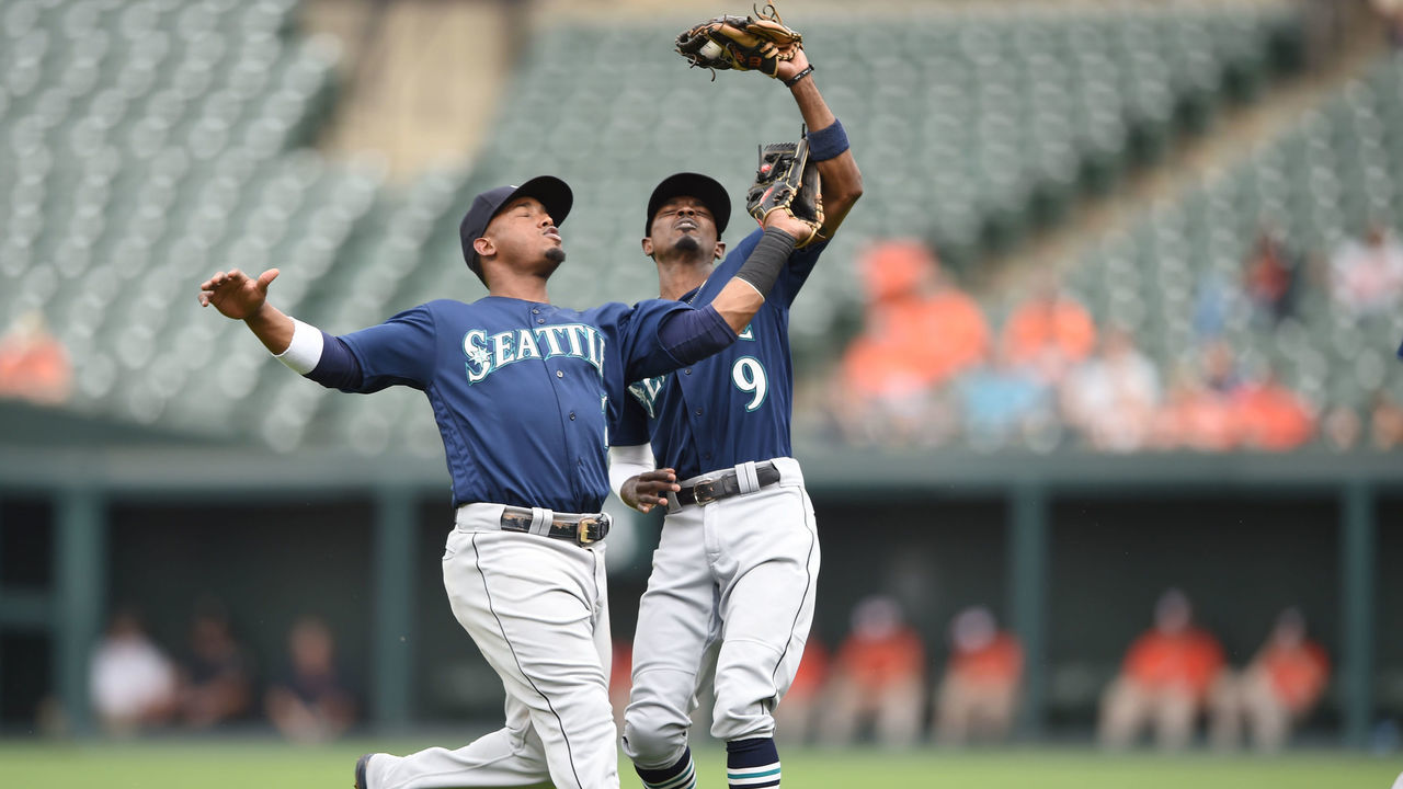 BALTIMORE, MD - JUNE 28: Dee Gordon #9 of the Seattle Mariners catches a op up over Jean Segura #2 on a Steve Wilkerson #12 (not pictured) hitted ball in the third inning during a baseball game against the Seattle Mariners at Oriole Park at Camden yards on June 23, 2018 in Baltimore, Maryland.