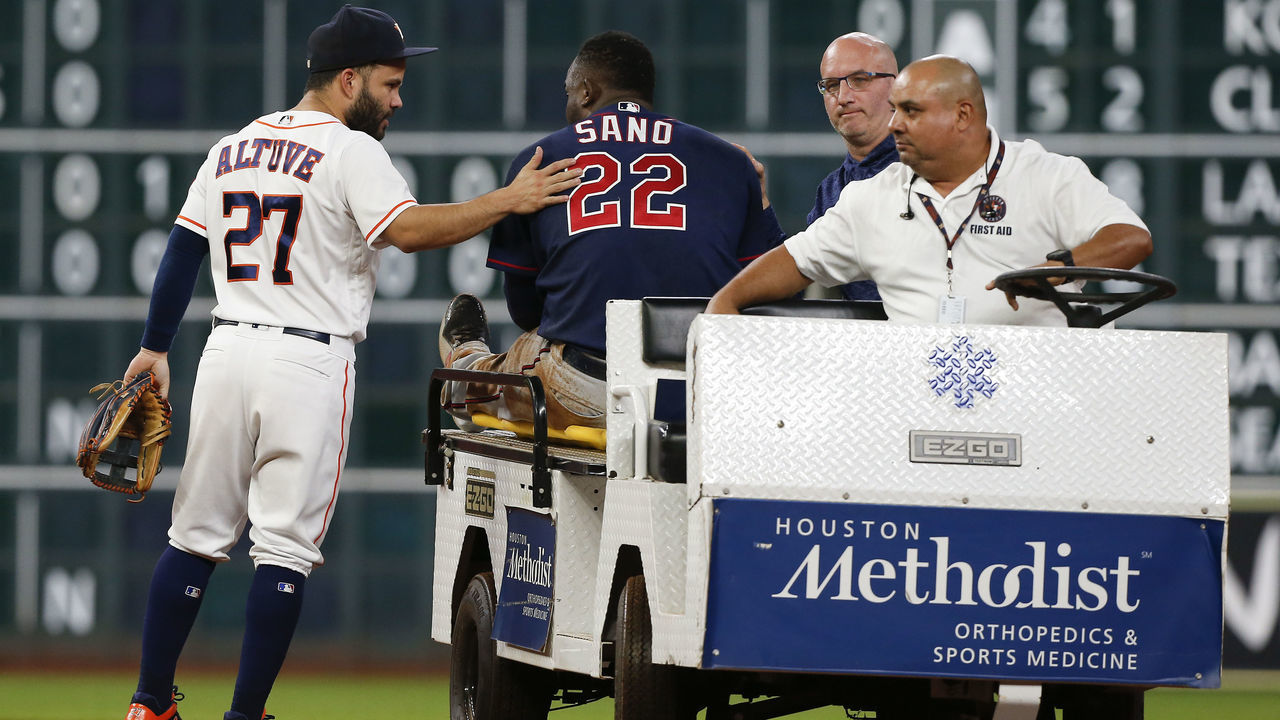 HOUSTON, TX - SEPTEMBER 04: Jose Altuve #27 of the Houston Astros gives Miguel Sano #22 of the Minnesota Twins a pat onk the back as he carted off in the second inning after sustaining an injury sliding into second base at Minute Maid Park on September 4, 2018 in Houston, Texas.