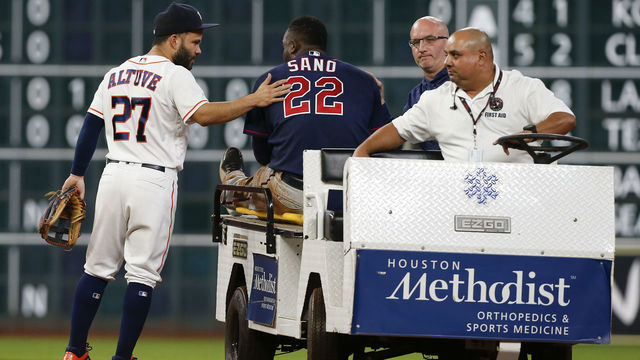 HOUSTON, TX - SEPTEMBER 04: Jose Altuve #27 of the Houston Astros gives Miguel Sano #22 of the Minnesota Twins a pat onk the back as he carted off in the second inning after sustaining an injury sliding into second base at Minute Maid Park on September 4, 2018 in Houston, Texas.