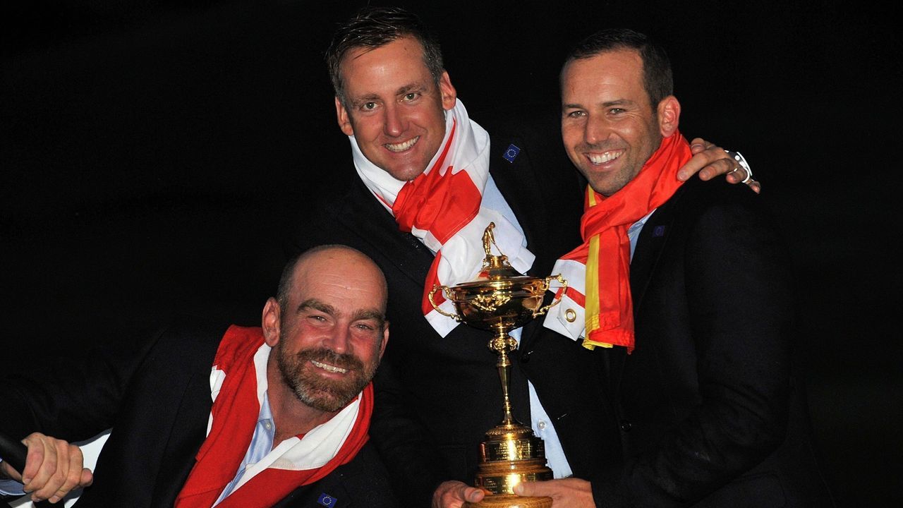 Thomas Bjorn of Denmark (L) Ian Poulter of England (C) and Sergio Garcia of Spain pose for photographs after Team Europe retained the Ryder Cup on the final day of the Ryder Cup golf tournament at the Gleneagles Hotel in Gleneagles, Scotland, on September 28, 2014. Jamie Donaldson grabbed the crucial point Paul McGinley's side needed for the win when he defeated Keegan Bradley 4 and 3 in the 10th of the closing 12 singles. AFP PHOTO/GLYN KIRK