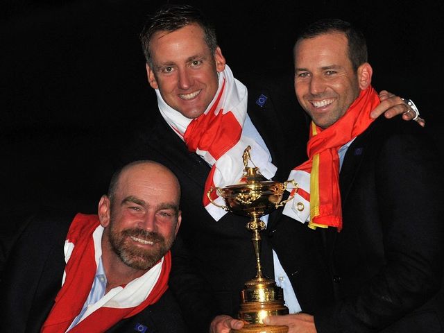 Thomas Bjorn of Denmark (L) Ian Poulter of England (C) and Sergio Garcia of Spain pose for photographs after Team Europe retained the Ryder Cup on the final day of the Ryder Cup golf tournament at the Gleneagles Hotel in Gleneagles, Scotland, on September 28, 2014. Jamie Donaldson grabbed the crucial point Paul McGinley's side needed for the win when he defeated Keegan Bradley 4 and 3 in the 10th of the closing 12 singles. AFP PHOTO/GLYN KIRK