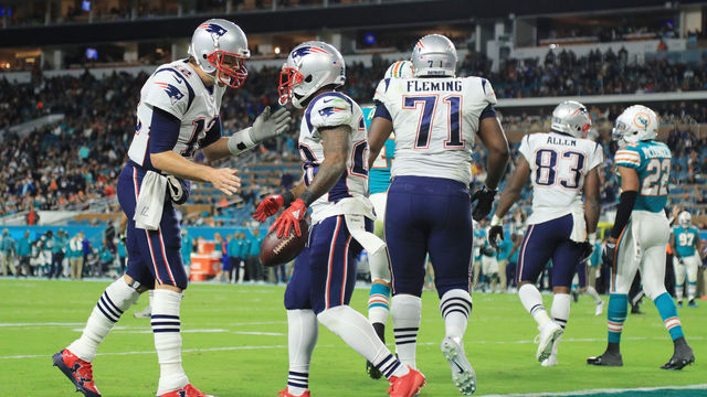 MIAMI GARDENS, FL - DECEMBER 11: James White #28 celebrates his touchdown with Tom Brady #12 of the New England Patriots in the fourth quarter against the Miami Dolphins at Hard Rock Stadium on December 11, 2017 in Miami Gardens, Florida.