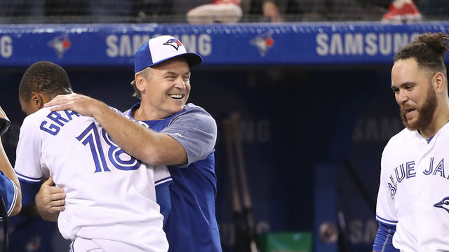 TORONTO, ON - APRIL 24: Curtis Granderson #18 of the Toronto Blue Jays is congratulated by manager John Gibbons #5 after hitting a game-winning solo home run in the tenth inning during MLB game action against the Boston Red Sox at Rogers Centre on April 24, 2018 in Toronto, Canada.
