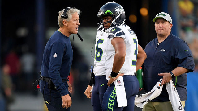 CARSON, CA - AUGUST 18: Russell Wilson #3 of the Seattle Seahawks and head coach Pete Carroll talk during the first quarter of a presseason game against the Los Angeles Chargers at StubHub Center on August 18, 2018 in Carson, California.