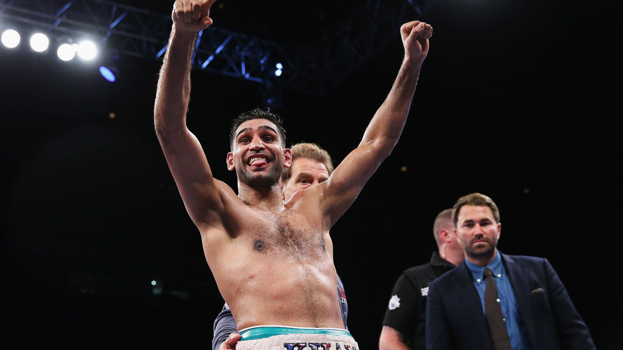 BIRMINGHAM, ENGLAND - SEPTEMBER 08: Amir Khan of England celebrates victory with his team over Samuel Vargas of Canada during their Welterweight bout held at Arena Birmingham on September 8, 2018 in Birmingham, England.