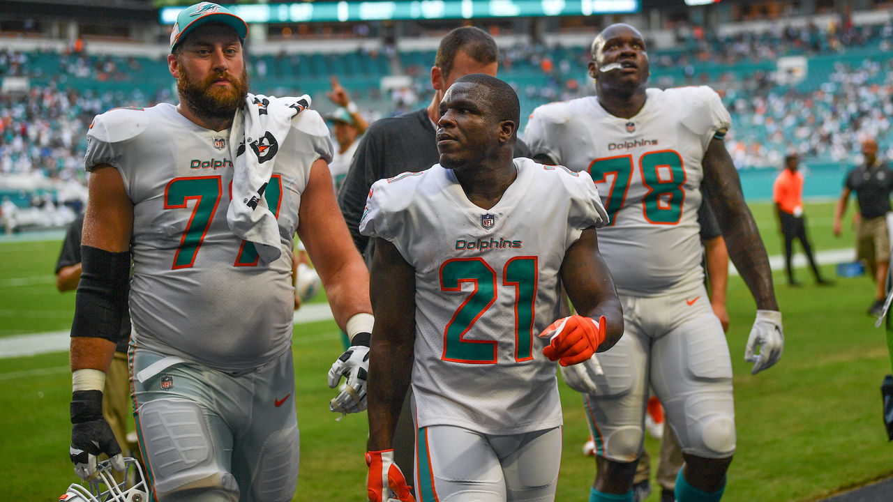 MIAMI, FL - SEPTEMBER 09: (L-R) Jesse Davis #77, Frank Gore #21, and Laremy Tunsil #78 of the Miami Dolphins head to the locker room during a lightning delay in the third quarter against the Tennessee Titans at Hard Rock Stadium on September 9, 2018 in Miami, Florida.