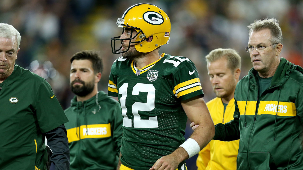 GREEN BAY, WI - SEPTEMBER 09: Aaron Rodgers #12 of the Green Bay Packers is helped off the field after injuring his leg in the second quarter of a game against the Chicago Bears at Lambeau Field on September 9, 2018 in Green Bay, Wisconsin.