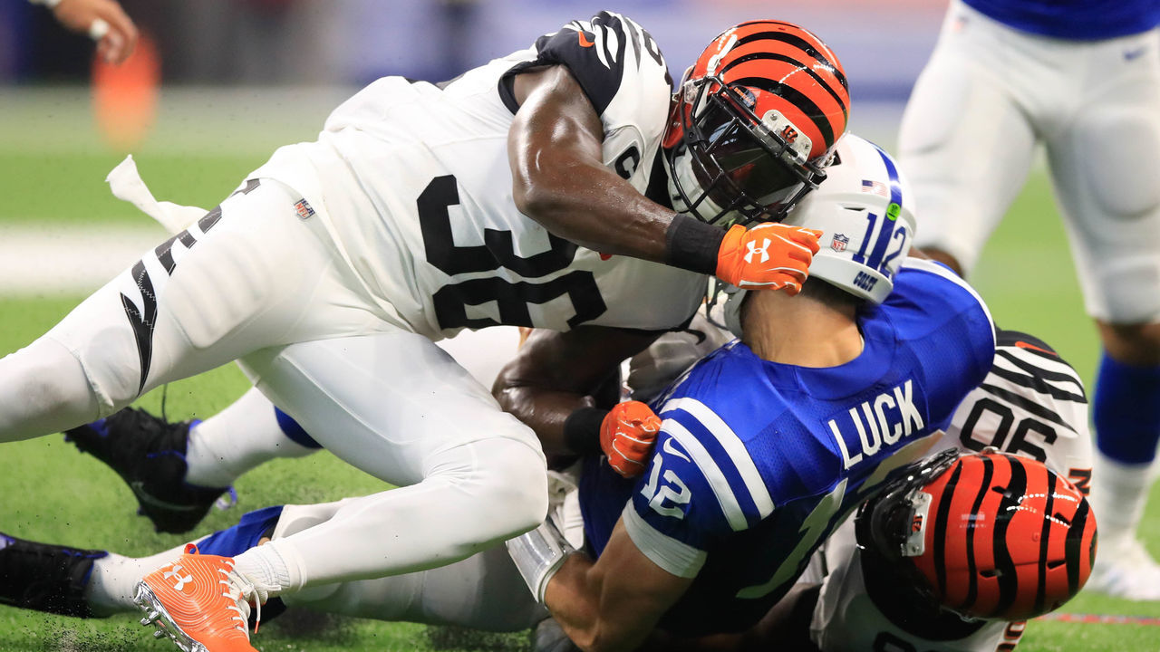 INDIANAPOLIS, IN - SEPTEMBER 09: Andrew Luck #12 of the Indianapolis Colts is taken down by Darius Phillips #38 and Michael Johnson #90 of the Cincinnati Bengals at Lucas Oil Stadium on September 9, 2018 in Indianapolis, Indiana.