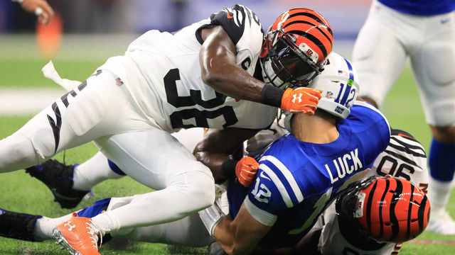 INDIANAPOLIS, IN - SEPTEMBER 09: Andrew Luck #12 of the Indianapolis Colts is taken down by Darius Phillips #38 and Michael Johnson #90 of the Cincinnati Bengals at Lucas Oil Stadium on September 9, 2018 in Indianapolis, Indiana.