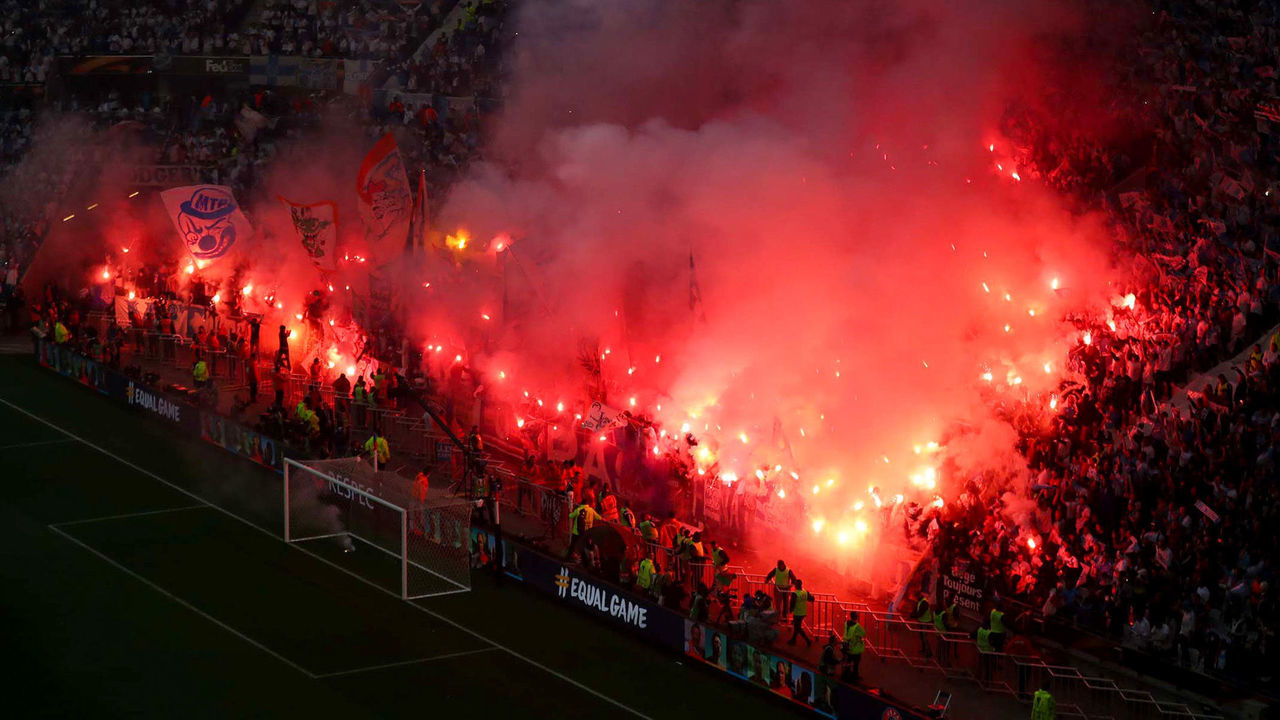LYON, FRANCE - MAY 16: Marseille fans light flares during the UEFA Europa League Final between Olympique de Marseille and Club Atletico de Madrid at Stade de Lyon on May 16, 2018 in Lyon, France.