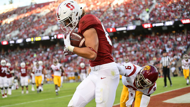 PALO ALTO, CA - SEPTEMBER 08: Colby Parkinson #84 of the Stanford Cardinal catches a touchdown pass over Greg Johnson #9 of the USC Trojans in the second quarter of an NCAA football game at Stanford Stadium on September 8, 2018 in Palo Alto, California.