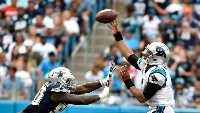 CHARLOTTE, NC - SEPTEMBER 09: Cam Newton #1 of the Carolina Panthers passes over Demarcus Lawrence #90 of the Dallas Cowboys in the third quarter during their game at Bank of America Stadium on September 9, 2018 in Charlotte, North Carolina.