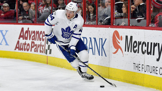 RALEIGH, NC - NOVEMBER 24: Morgan Rielly #44 of the Toronto Maple Leafs moves the puck against the Carolina Hurricanes during thir game at PNC Arena on November 24, 2017 in Raleigh, North Carolina.