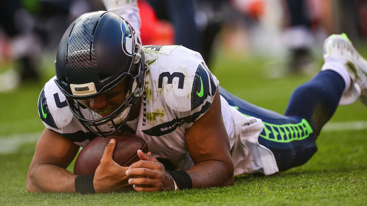 DENVER, CO - SEPTEMBER 9: Quarterback Russell Wilson #3 of the Seattle Seahawks hits the ground after being tripped while scrambling in the fourth quarter of a game against the Denver Broncos at Broncos Stadium at Mile High on September 9, 2018 in Denver, Colorado.
