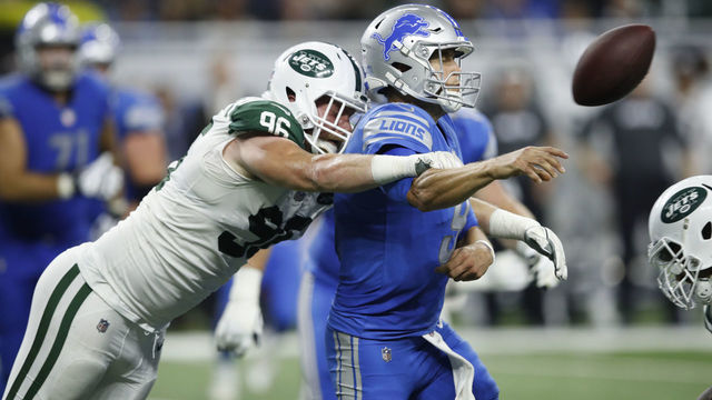 DETROIT, MI - SEPTEMBER 10: Matthew Stafford #9 of the Detroit Lions throws an incomplete pass under pressure from Henry Anderson #96 of the New York Jets in the third quarter at Ford Field on September 10, 2018 in Detroit, Michigan.