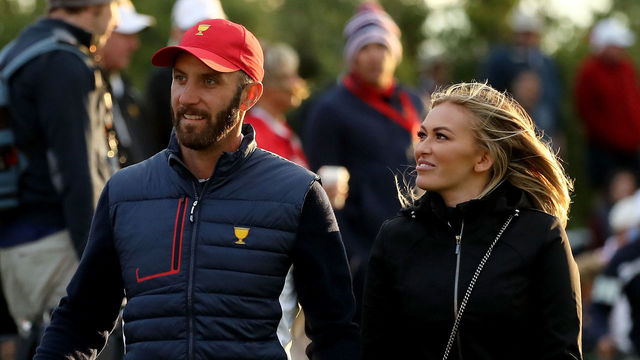 JERSEY CITY, NJ - SEPTEMBER 30: Dustin Johnson of the U.S. Team and Paulina Gretzky walk on the 18th green during Saturday four-ball matches of the Presidents Cup at Liberty National Golf Club on September 30, 2017 in Jersey City, New Jersey.