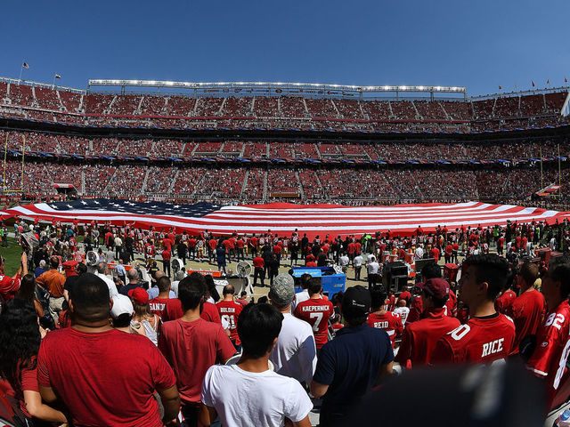 A flag is presented on the field of Levi's Stadium during the national  anthem before an NFL football game between the San Francisco 49ers and the  New York Giants in Santa Clara