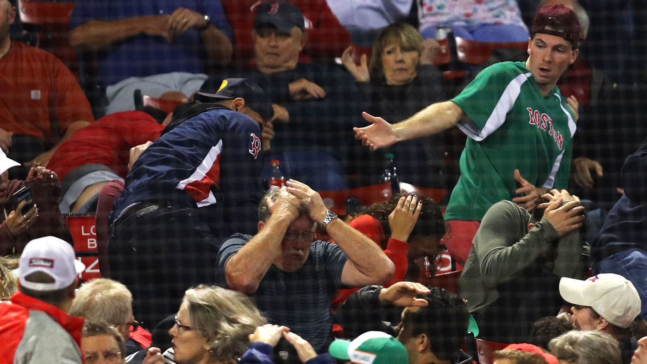 BOSTON, MA - SEPTEMBER 12: Fans react after Devon Travis #29 of the Toronto Blue Jays lost control of the bat and it flew into the stands during the eighth inning of the game between the Boston Red Sox and the Toronto Blue Jays at Fenway Park on September 12, 2018 in Boston, Massachusetts.