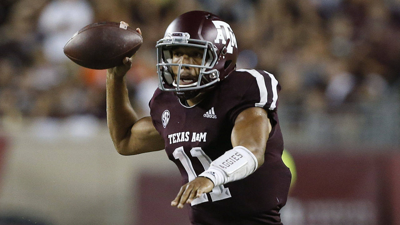 COLLEGE STATION, TX - SEPTEMBER 08: Kellen Mond #11 of the Texas A&M Aggies throws a patch for a touchdown as he is pressured by Isaiah Simmons #11 of the Clemson Tigers in the second half at Kyle Field on September 8, 2018 in College Station, Texas.