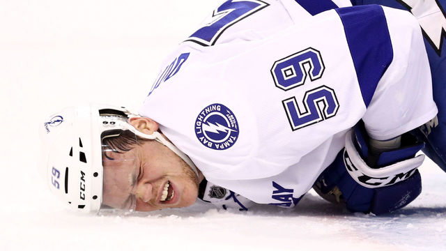 BOSTON, MA - APRIL 4: Jake Dotchin #59 of the Tampa Bay Lightning reacts to an injury during the first period against the Boston Bruins at TD Garden on April 4, 2017 in Boston, Massachusetts.