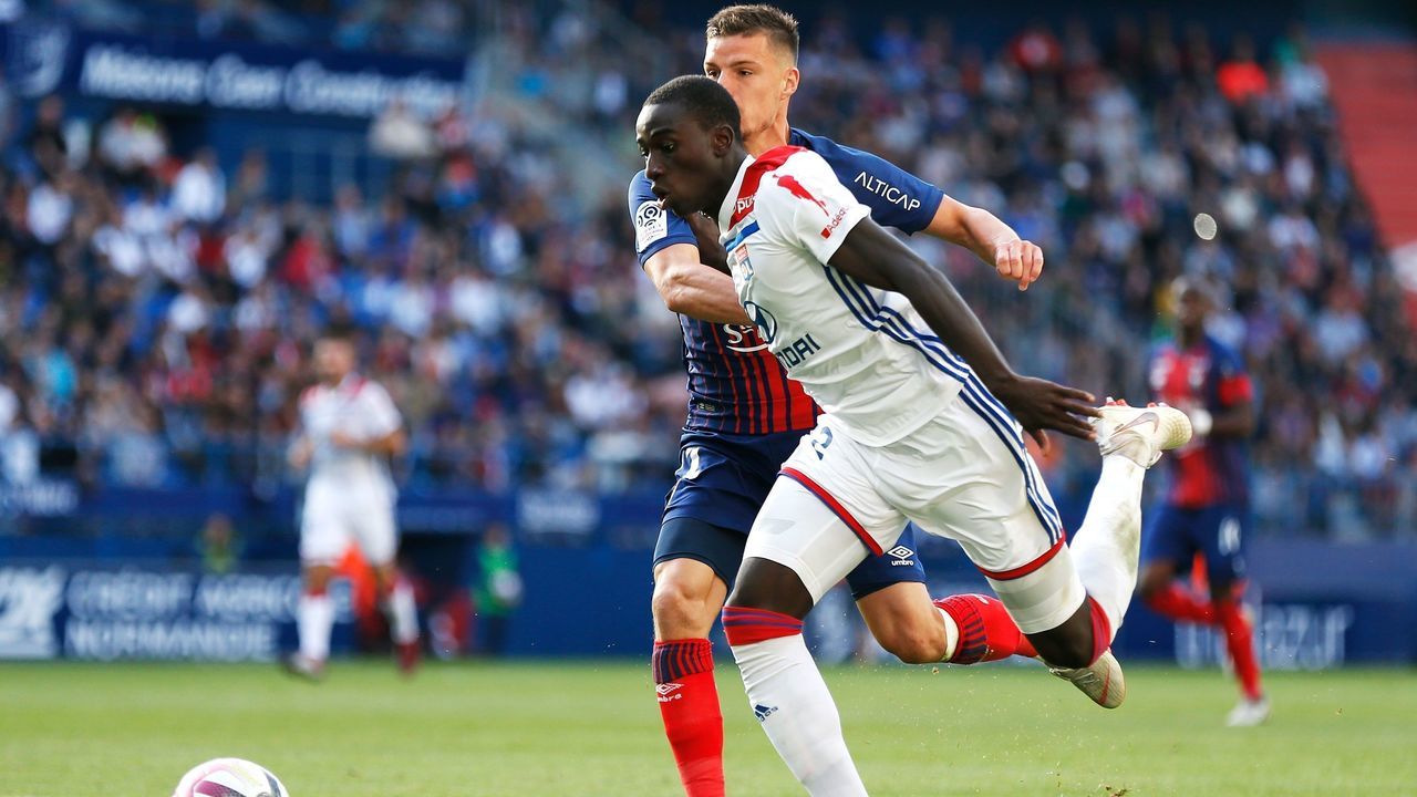 Caen's French defender Frederic Guilbert (L) vies for the ball with Lyon's French defender Ferland Mendy (R) during the French L1 football match between Caen (SMC) and Lyon (OL) on September 15, 2018, at the Michel d'Ornano stadium, in Caen, northwestern France.