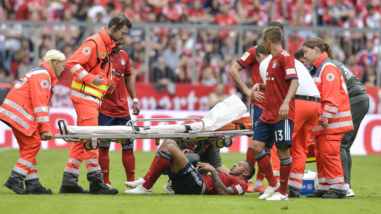 Bayern Munich's French midfielder Corentin Tolisso lies injured on the pitch during the German First division Bundesliga football match between FC Bayern Munich and Bayer Leverkusen in Munich, on September 15, 2018.
