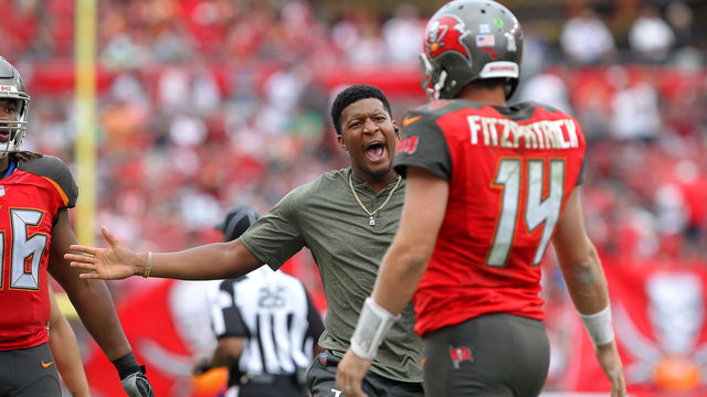 TAMPA, FL - NOV 12: Injured quarterback Jameis Winston is excited for starting quarterback Ryan Fitzpatrick (14) as Fitzpatrick walks back to the sideline after throwing a touchdown during the regular season game between the New York Jets and the Tampa Bay Buccaneers on November 12, 2017 at Raymond James Stadium in Tampa, Florida.