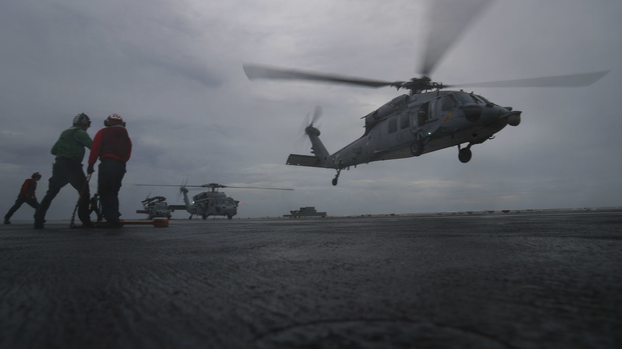 ATLANTIC OCEAN - SEPTEMBER 15: In this handout photo provided by the U.S. Navy,MH-60S Sea Hawk helicopters from the 'Dusty Dogs' of Helicopter Sea Combat Squadron (HSC) 7, attached to Carrier Strike Group 12 and the Nimitz-class aircraft carrier USS Abraham Lincoln (CVN 72), are recalled to Naval Station Norfolk, where they will be better postured to provide land-based rotary wing Defense Support of Civil Authorities if required in the aftermath of Hurricane Florence. Abraham Lincoln remains underway after Commander, U.S. Fleet Forces Command ordered all U.S. Navy ships in the Hampton Roads area to sortie on Sept. 10, ahead of the storm, which continues to bring high winds and rain to the Mid-Atlantic coast.