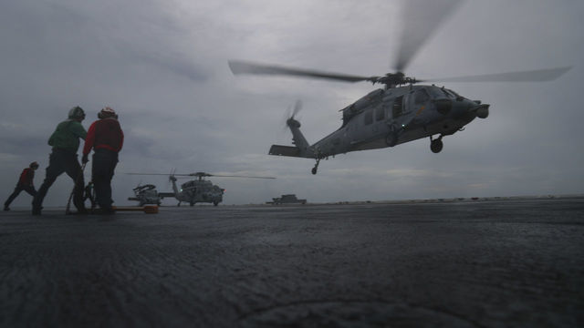 ATLANTIC OCEAN - SEPTEMBER 15: In this handout photo provided by the U.S. Navy,MH-60S Sea Hawk helicopters from the 'Dusty Dogs' of Helicopter Sea Combat Squadron (HSC) 7, attached to Carrier Strike Group 12 and the Nimitz-class aircraft carrier USS Abraham Lincoln (CVN 72), are recalled to Naval Station Norfolk, where they will be better postured to provide land-based rotary wing Defense Support of Civil Authorities if required in the aftermath of Hurricane Florence. Abraham Lincoln remains underway after Commander, U.S. Fleet Forces Command ordered all U.S. Navy ships in the Hampton Roads area to sortie on Sept. 10, ahead of the storm, which continues to bring high winds and rain to the Mid-Atlantic coast.
