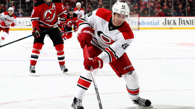 NEWARK, NJ - MARCH 25: Victor Rask #49 of the Carolina Hurricanes takes the puck as Travis Zajac #19 of the New Jersey Devils defends on March 25, 2017 at Prudential Center in Newark, New Jersey.