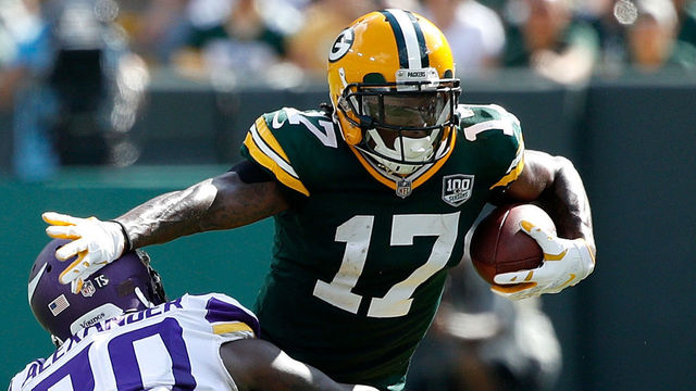 GREEN BAY, WI - SEPTEMBER 16: Davante Adams #17 of the Green Bay Packers is tackled by Mackensie Alexander #20 of the Minnesota Vikings after making a catch in the fourth quarter of a game at Lambeau Field on September 16, 2018 in Green Bay, Wisconsin.