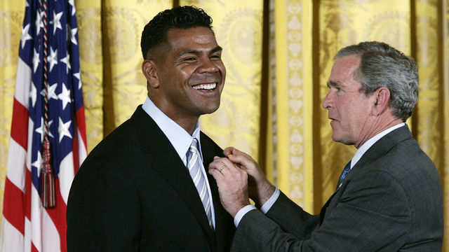 WASHINGTON - MAY 25: U.S. President George W. Bush presents an award to receipient Miami Dolphins linebacker Junior Seau during the celebration of Asian Pacific American Heritage Month and presentation of the President?s Volunteer Service Awards at the East Room of the White House May 25, 2005 in Washington, DC. The President?s Volunteer Service Award was created to recognize Americans who have made a sustained commitment to volunteer service.