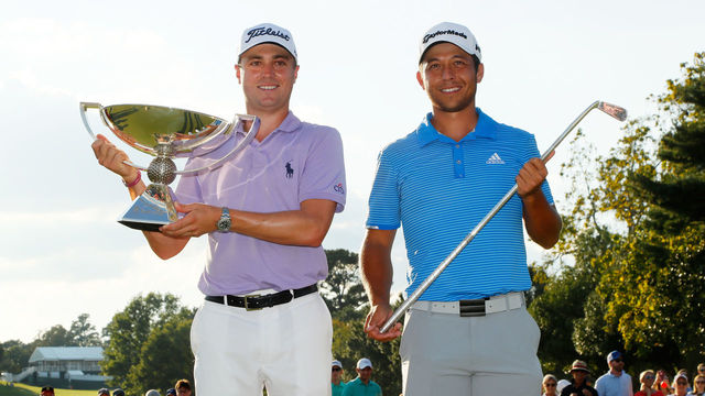 ATLANTA, GA - SEPTEMBER 24: Justin Thomas of the United States celebrates with the trophy on the 18th green after winning the FedExCup and second in the TOUR Championship as Xander Schauffele celebrates with the Calamity Jane trophy for winning the TOUR Championship after the final round at East Lake Golf Club on September 24, 2017 in Atlanta, Georgia.