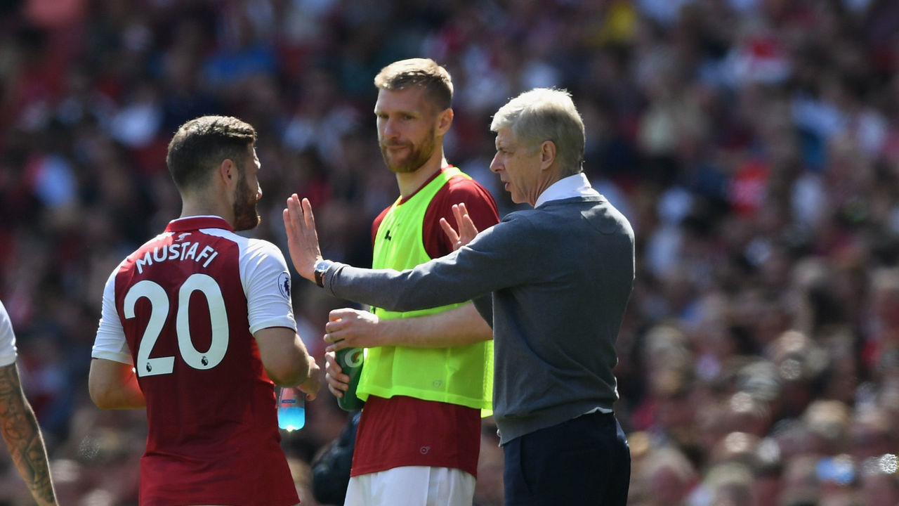 LONDON, ENGLAND - APRIL 22: Arsene Wenger, Manager of Arsenal and Per Mertesacker talk to Shkodran Mustafi of Arsenal during the Premier League match between Arsenal and West Ham United at Emirates Stadium on April 22, 2018 in London, England.