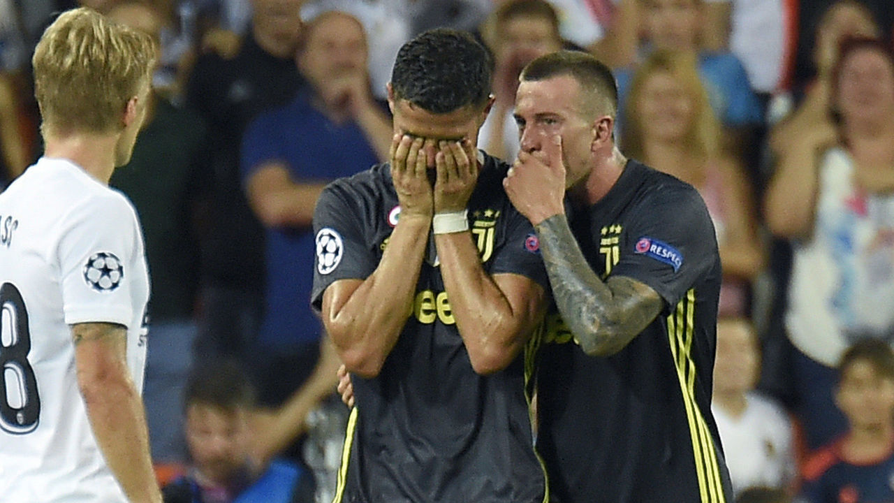 Juventus' Portuguese forward Cristiano Ronaldo (C) reacts after receiving a red card during the UEFA Champions League group H football match between Valencia CF and Juventus FC at the Mestalla stadium in Valencia on September 19, 2018.