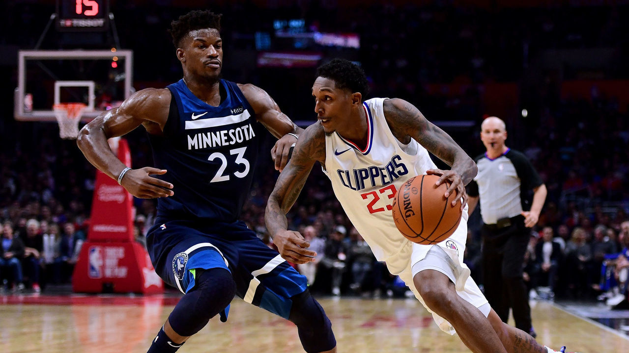 LOS ANGELES, CA - DECEMBER 06: Lou Williams #23 of the LA Clippers drives to the basket on Jimmy Butler #23 of the Minnesota Timberwolves during a 113-107 Timberwolves win at Staples Center on December 6, 2017 in Los Angeles, California.