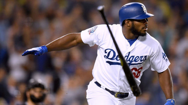 LOS ANGELES, CA - SEPTEMBER 19: Yasiel Puig #66 of the Los Angeles Dodgers tosses his bat in reaction to his three run homerun in front of Chris Iannetta #22 of the Colorado Rockies, to take a 5-2 lead during the seventh inning at Dodger Stadium on September 19, 2018 in Los Angeles, California.