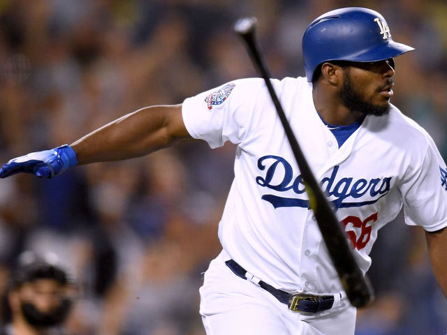 LOS ANGELES, CA - SEPTEMBER 19: Yasiel Puig #66 of the Los Angeles Dodgers tosses his bat in reaction to his three run homerun in front of Chris Iannetta #22 of the Colorado Rockies, to take a 5-2 lead during the seventh inning at Dodger Stadium on September 19, 2018 in Los Angeles, California.