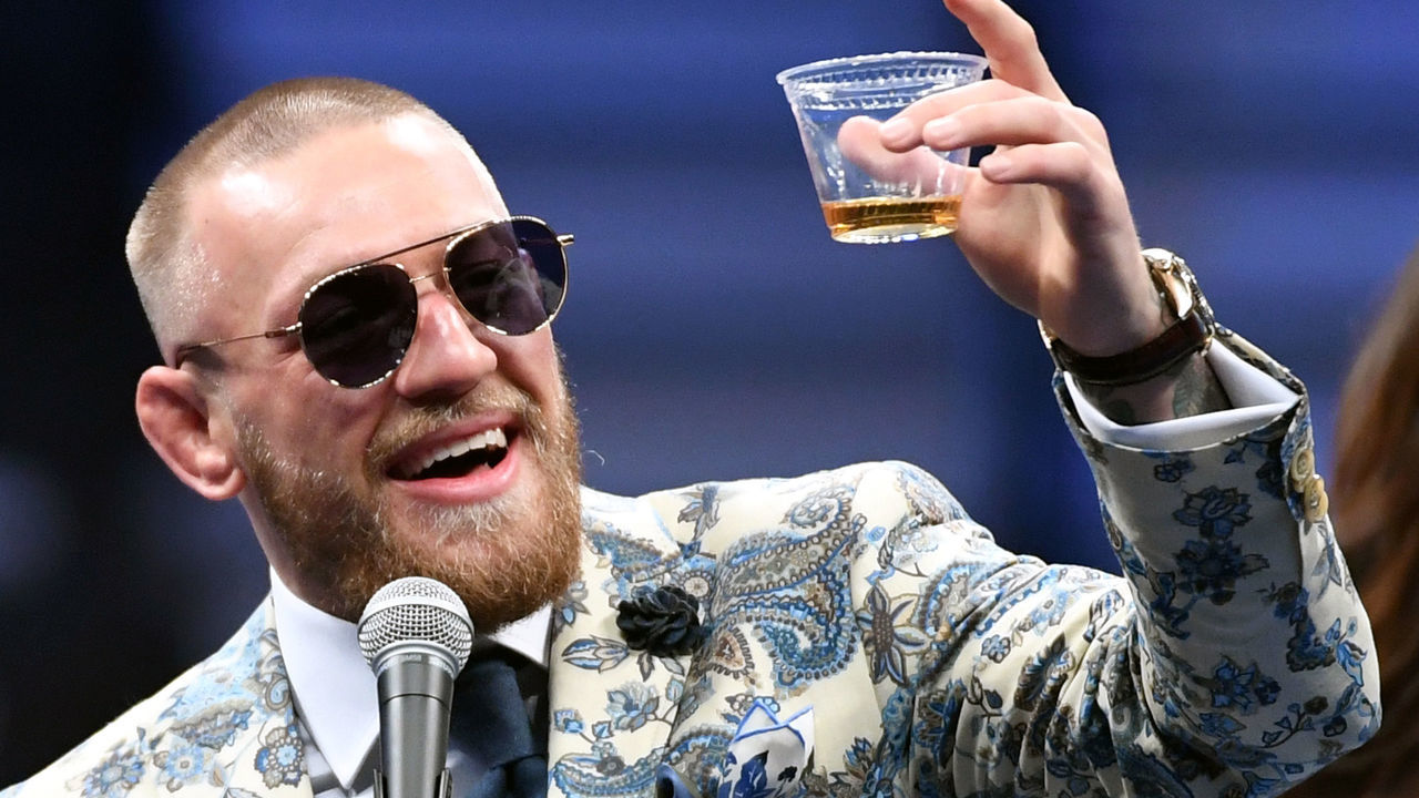 LAS VEGAS, NV - AUGUST 26: Conor McGregor holds up a cup of his Notorious-branded Irish whiskey as he speaks during a news conference following his 10th-round TKO loss to Floyd Mayweather Jr. in their super welterweight boxing match at T-Mobile Arena on August 26, 2017 in Las Vegas, Nevada.