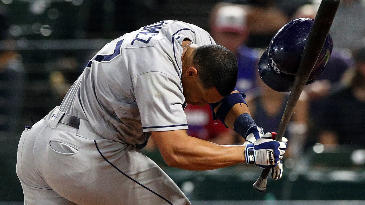 ARLINGTON, TX - SEPTEMBER 18: Carlos Gomez #27 of the Tampa Bay Rays reels after beign hit by a pitch in the ninth inning against the Texas Rangers at Globe Life Park in Arlington on September 18, 2018 in Arlington, Texas.