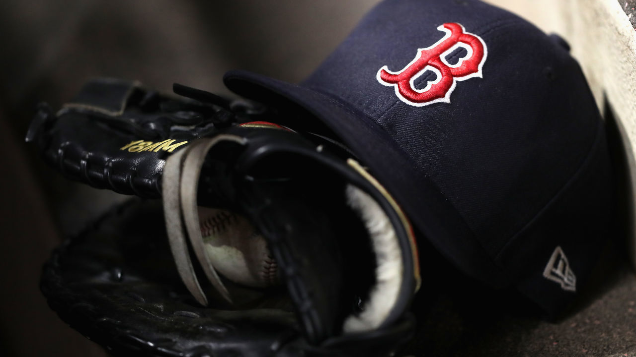 ANAHEIM, CA - APRIL 18: A detail of a Boston Red Sox hat and glove during a game against the Los Angeles Angels of Anaheim at Angel Stadium on April 18, 2018 in Anaheim, California.