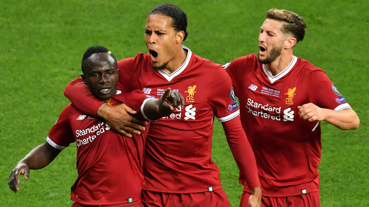 Liverpool's Senegalese midfielder Sadio Mane (L) celebrates with his teammates Liverpool's Dutch defender Virgil Van Dijk (C) and Liverpool's English midfielder Adam Lallana (R) after scoring the 1-1 during the UEFA Champions League final football match between Liverpool and Real Madrid at the Olympic Stadium in Kiev, Ukraine on May 26, 2018.